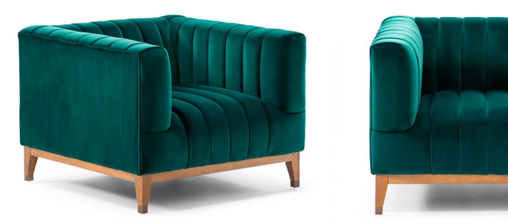 Emerald green velvet armchair with wooden legs on white background